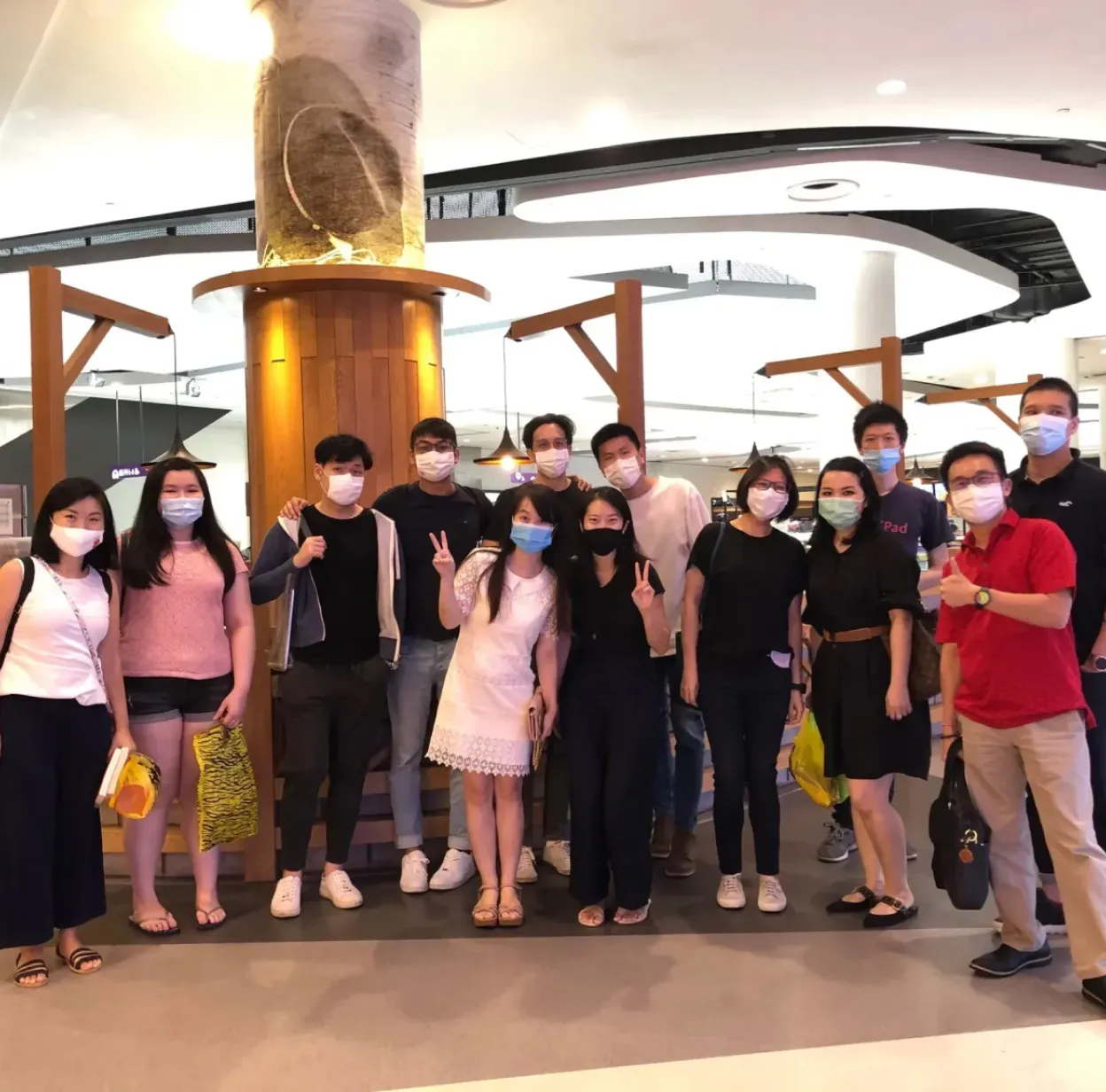 A group of people wearing face masks in an airport, prioritizing safety and following health guidelines.
